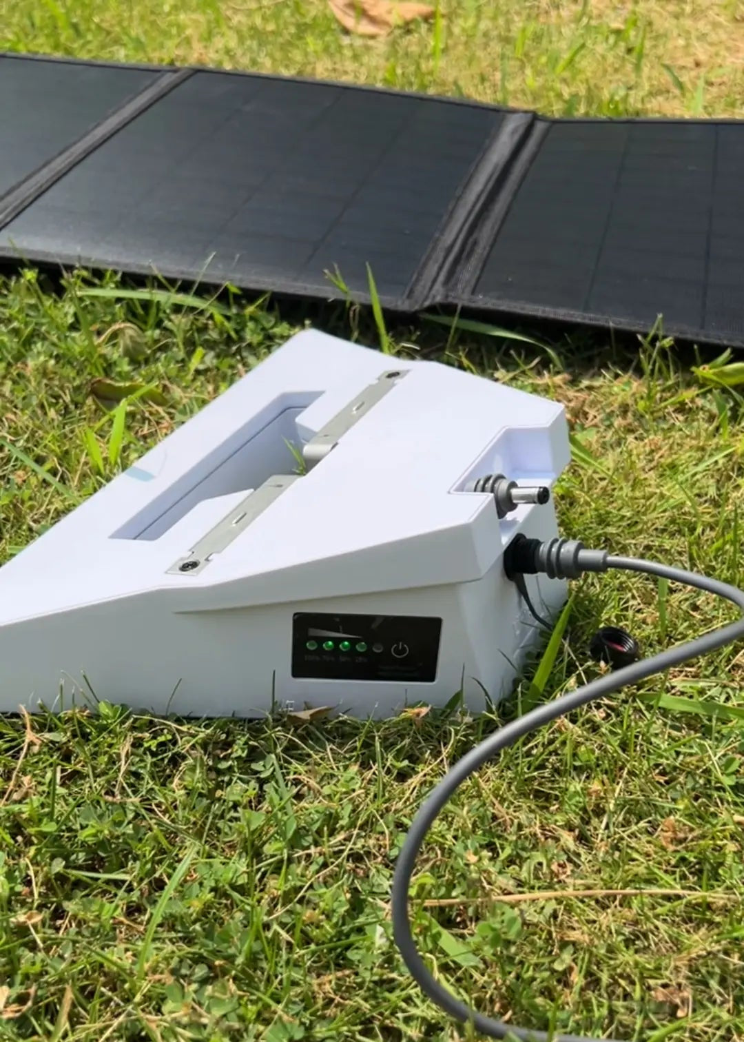 The Starlink Mini battery is being charged using a solar panel connected via the original Starlink charging cable.